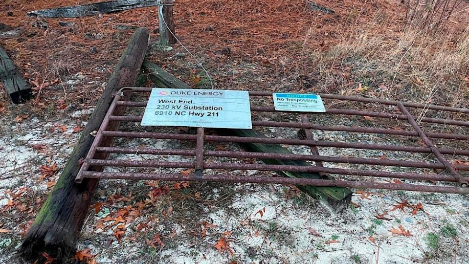 The damaged gate to the Duke Energy West End substation in Moore County, N.C., leads to a substation that was hit by gunfire in what officials say was a criminal act of vandalism on Saturday.