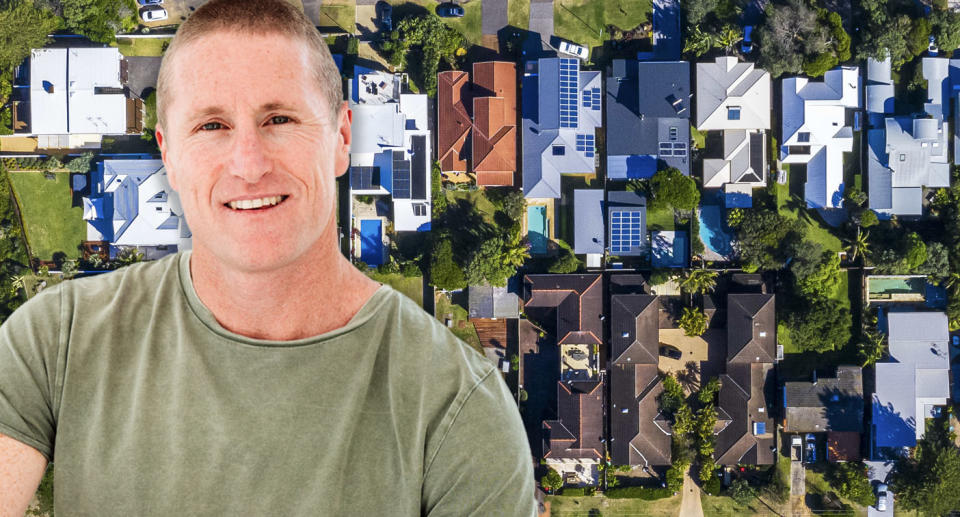 John Pidgeon in a green shirt in front of an aerial of houses.