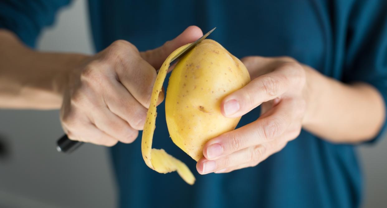 Woman peeling potatoes