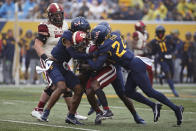 Oklahoma running back Eric Gray (0) is defended by West Virginia safety Marcis Floyd (24) during the first half of an NCAA college football game in Morgantown, W.Va., Saturday, Nov. 12, 2022. (AP Photo/Kathleen Batten)