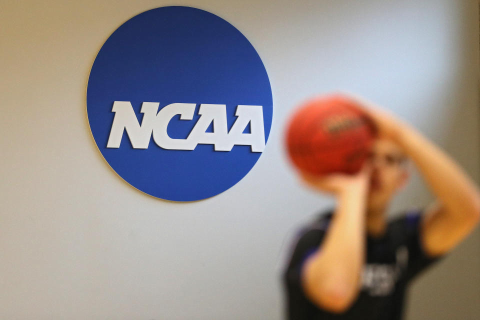 The NCAA logo is seen on the wall as Yeshiva players warmup prior to playing against Worcester Polytechnic Institute during the NCAA Division III Men's Basketball Championship - First Round at Goldfarb Gymnasium on at Johns Hopkins University on March 6, 2020 in Baltimore, Maryland. On Thursday, Maryland Gov. Larry Hogan announced that Maryland had confirmed three cases of residents with COVID-19, otherwise known as the Coronavirus, prompting Johns Hopkins officials to host the NCAA men's basketball tournament without spectators. (Photo by Patrick Smith/Getty Images)