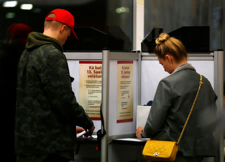 People vote during a general election at a polling station in Riga, Latvia October 6, 2018. REUTERS/Ints Kalnins