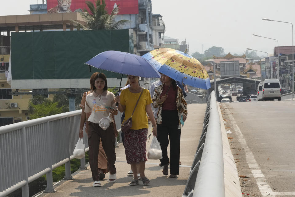 Myanmar residents cross the 1st Thai-Myanmar Friendship Bridge in Mae Sot in Thailand's Tak province on Friday, April 12, 2024. Thailand’s foreign minister says he has urged Myanmar’s military authorities not to violently respond to its army’s loss of an important border trading town to its opponents, and that so far it seemed to be exercising restraint. (AP Photo/Sakchai Lalit)