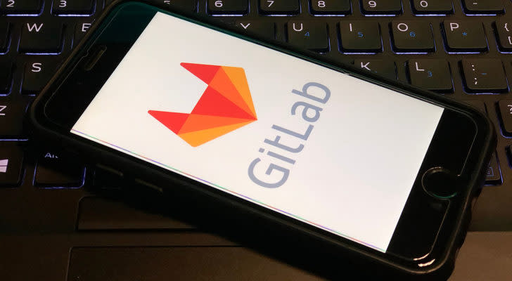 The GitLab (GTLB) logo on an iPhone screen.