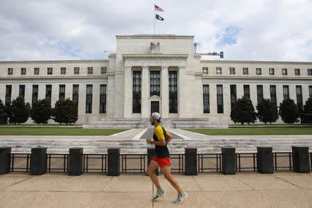 A jogger runs past the Federal Reserve building in Washington, DC, U.S., August 22, 2018. REUTERS/Chris Wattie