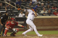 New York Mets' Dominic Smith hits a two-run double during the fifth inning of a baseball game against the Philadelphia Phillies, Sunday, Sept. 19, 2021, in New York. (AP Photo/Jason DeCrow)