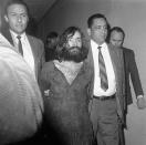<p>Charles Manson, leader of a cult of hippies, is taken to court on Dec. 10, 1969, in Independence, Calif., for a preliminary hearing on charges of possessing stolen property. (Photo: Harold Filan/AP) </p>