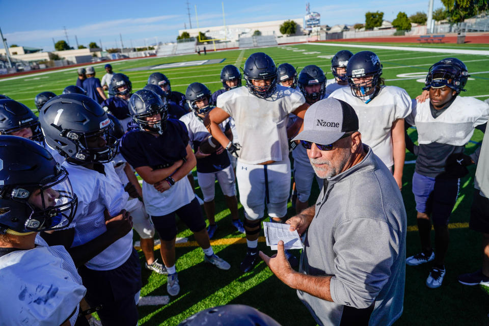Higley High School football offensive coordinator Noel Mazzone (right), talks with student-athletes during a practice at the campus football field in Gilbert on Nov. 15, 2022.
