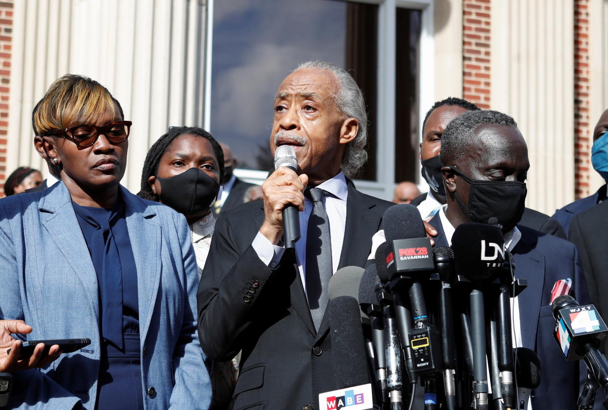 The Reverend Al Sharpton holds a microphone as he speaks during a news conference outside the Glynn County courthouse in Brunswick, Georgia. 
