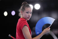 Evita Griskenas from the United States uses a hand fan during a break of her individual rhythmic gymnastics training session at the 2020 Summer Olympics, Thursday, Aug. 5, 2021, in Tokyo, Japan. (AP Photo/Markus Schreiber)