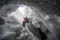 'Mount Erebus Ice Cave.' A scientist climbs out of an ice cave formed by volcanic vents near the summit of Mt. Erebus, Antarctica. (Photo and caption by Alasdair Turner/National Geographic Traveler Photo Contest) <br> <a href="http://travel.nationalgeographic.com/travel/traveler-magazine/photo-contest/2013/" rel="nofollow noopener" target="_blank" data-ylk="slk:See more and submit;elm:context_link;itc:0;sec:content-canvas" class="link ">See more and submit</a>