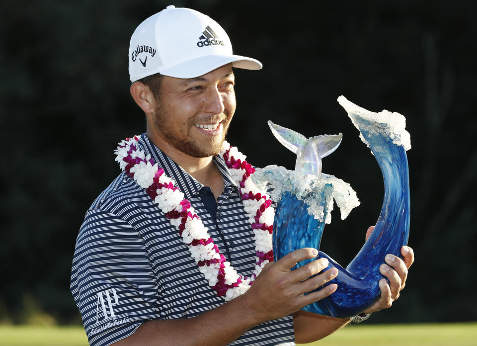 Xander Schauffele holds the champions trophy after the final round of the Tournament of Champions golf event, Sunday, Jan. 6, 2019, at Kapalua Plantation Course in Kapalua, Hawaii. (AP Photo/Matt York)