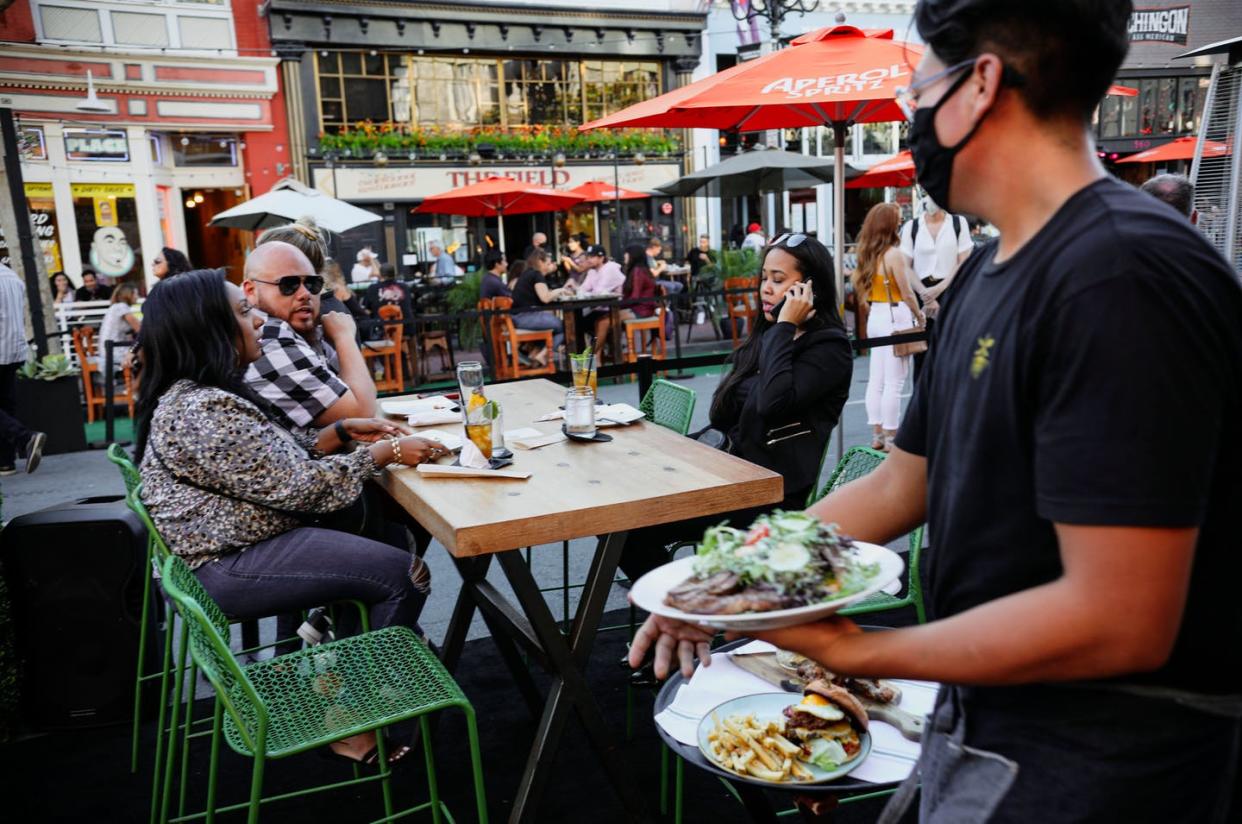 <span class="caption">States have tried shutting down bars and limiting restaurants to outdoor seating to slow the coronavirus's spread.</span> <span class="attribution"><a class="link " href="http://gettyimages.com/detail/news-photo/patrons-dine-at-an-outdoor-restaurant-along-5th-avenue-in-news-photo/1227674724" rel="nofollow noopener" target="_blank" data-ylk="slk:Sandy Huffaker/Getty Images;elm:context_link;itc:0;sec:content-canvas">Sandy Huffaker/Getty Images</a></span>