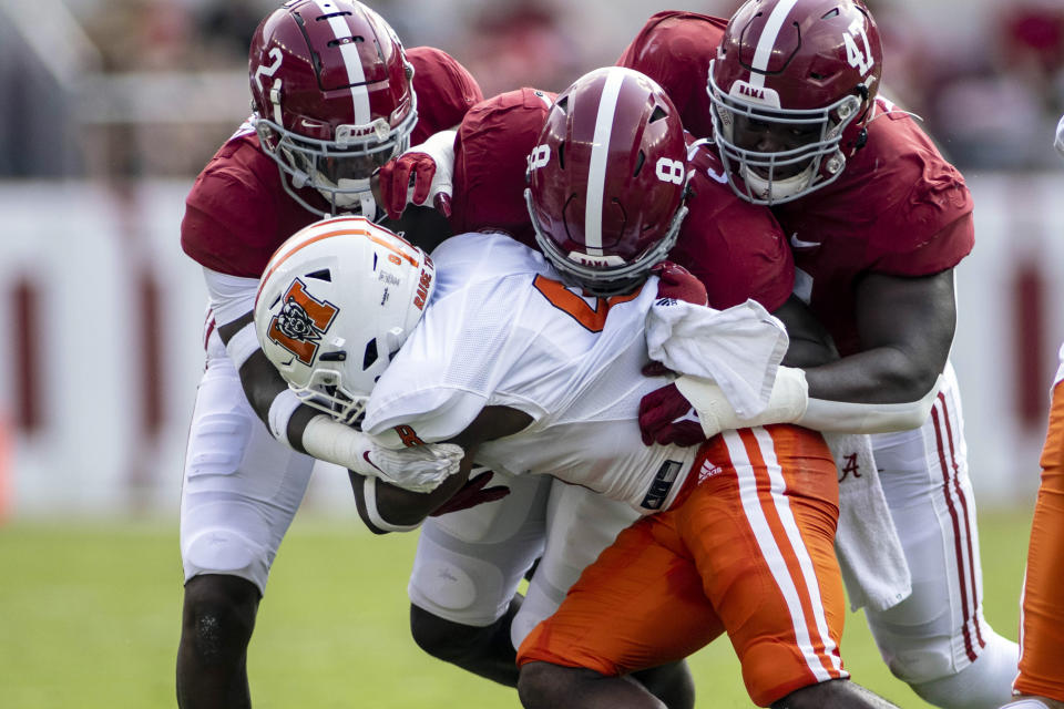 Alabama defensive back DeMarcco Hellams (2), linebacker Christian Harris (8) and defensive lineman Byron Young (47) stop Mercer quarterback Fred Payton (4) during the first half of an NCAA college football game, Saturday, Sept. 11, 2021, in Tuscaloosa, Ala. (AP Photo/Vasha Hunt)
