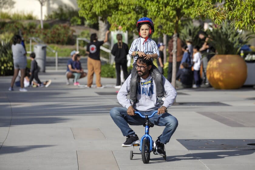 San Diego, CA - April 27: Zabihullah Khan, 26, keeps entertained his 4-year-old brother Mojibullah Khan on a trip to nearby park. Khans fled Afghanistan but their parents and sibling didn't make the evacuation flight. Zabihullah feels like he's a mom to his baby brother and has to juggle trying to find work with taking care of his sibling. Both are staying at a local hotel on Wednesday, April 27, 2022 in San Diego, CA. (Irfan Khan / Los Angeles Times)