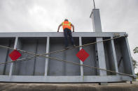 Plaquemines Parish, La., crews prepare to move a levee gate as they get ready for Hurricane Sally on Monday, Sept. 14, 2020. (Chris Granger/The Advocate via AP)