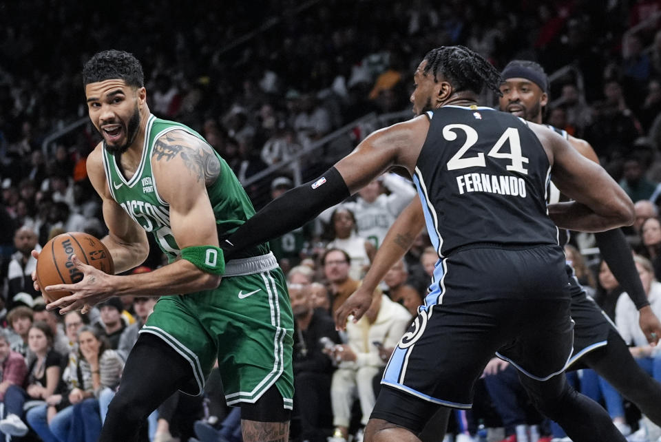 Boston Celtics forward Jayson Tatum (0) tries to get around Atlanta Hawks forward Bruno Fernando (24) during the second half of an NBA basketball game Monday, March 25, 2024, in Atlanta. (AP Photo/John Bazemore)