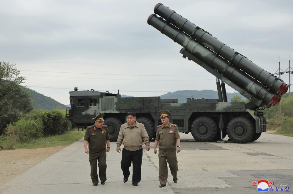 In this undated photo provided on Friday, Sept. 13, 2024, by the North Korean government, its leader Kim Jong Un, center, walks with other officials near what it says is their new launch vehicle of 600mm multiple rockets at an undisclosed location in North Korea. Independent journalists were not given access to cover the event depicted in this image distributed by the North Korean government. The content of this image is as provided and cannot be independently verified. Korean language watermark on image as provided by source reads: "KCNA" which is the abbreviation for Korean Central News Agency. (Korean Central News Agency/Korea News Service via AP)