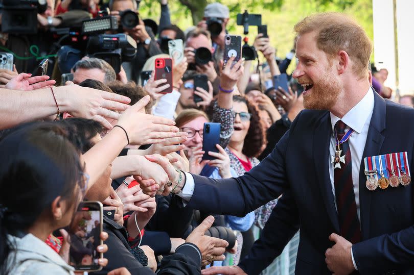 Prince Harry greets the public while departing The Invictus Games Foundation 10th Anniversary Service at St Paul's Cathedral