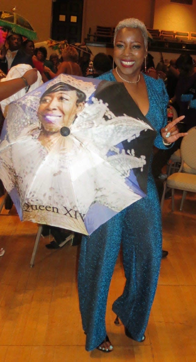 Former Sobek Queen Renee Davis uses her "custom-made" umbrella in the second line dance.