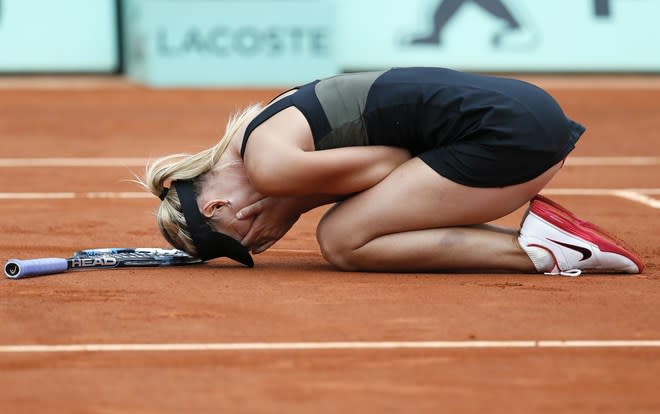Russia's Maria Sharapova celebrates after winning against Italy's Sara Errani their Women's Singles final tennis match of the French Open tennis tournament at the Roland Garros stadium, on June 9, 2012 in Paris. AFP PHOTO / JACQUES DEMARTHONJACQUES DEMARTHON/AFP/GettyImages