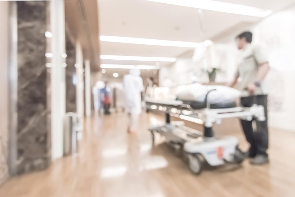 Blur background nurse staff working on hospital corridor lift hall with patient stretcher bed from emergency room