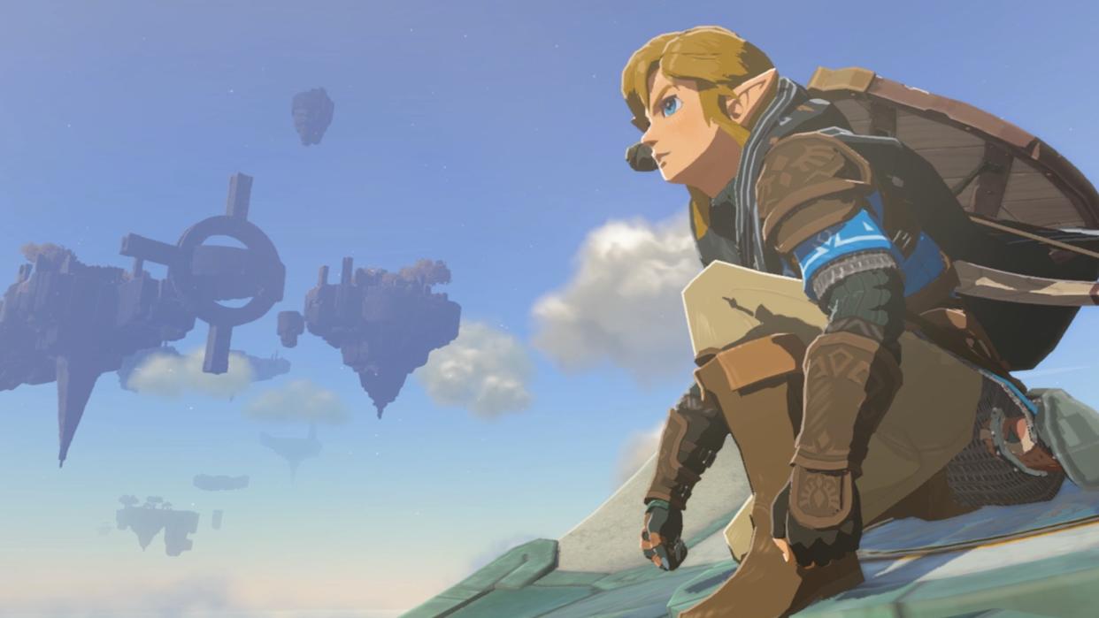  Link crouches, looking out over Hyrule. A sky island can be seen floating in the background 