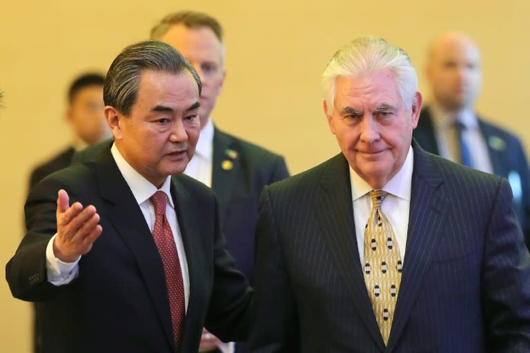 China's Foreign Minister Wang Yi (L) and US Secretary of State Rex Tillerson arrive for a joint press conference at the Diaoyutai State Guesthouse in Beijing, on March 18, 2017