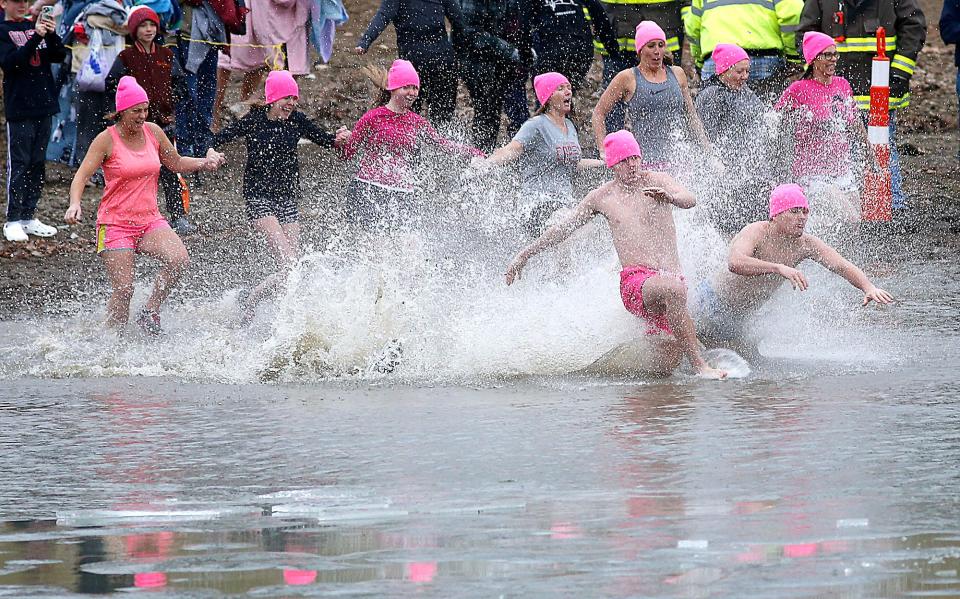 Participants take the plug into the lake during the Relay for Life of Ashland County-Mid-Ohio's annual Polar Bear Dip at Charles Mill Lake this year. The plunge will be held this year on Monday.