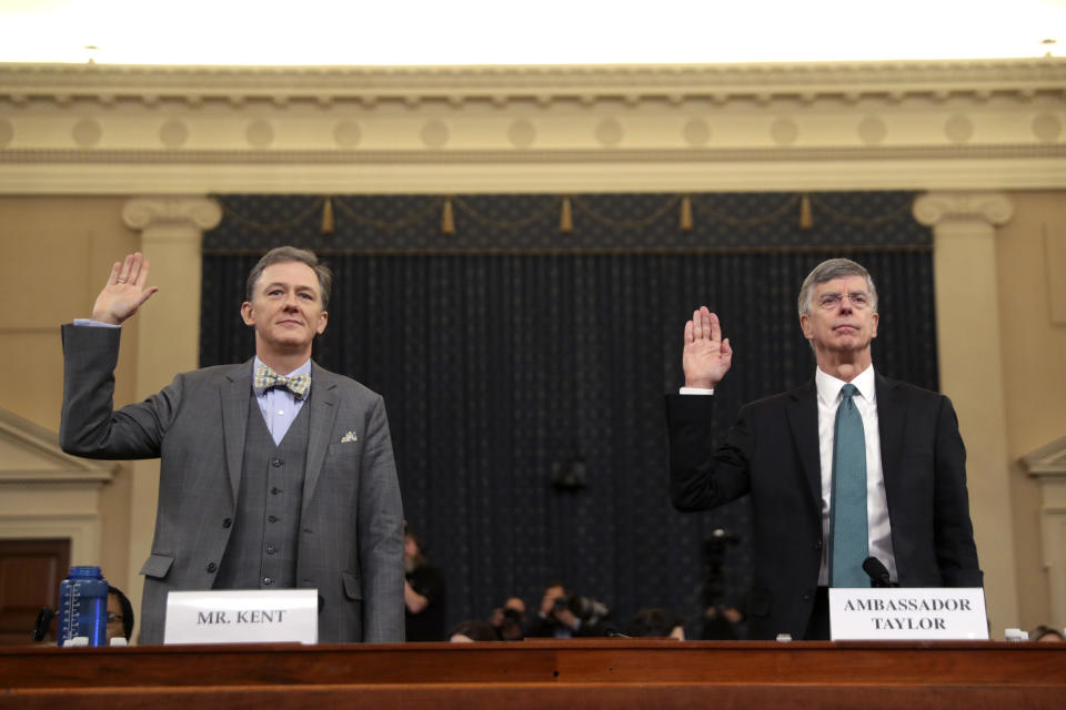 Career Foreign Service officer George Kent and top U.S. diplomat in Ukraine William Taylor, right, are sworn in to testify during the first public impeachment hearing of the House Intelligence Committee on Capitol Hill, Wednesday Nov. 13, 2019 in Washington.(AP Photo/Andrew Harnik)