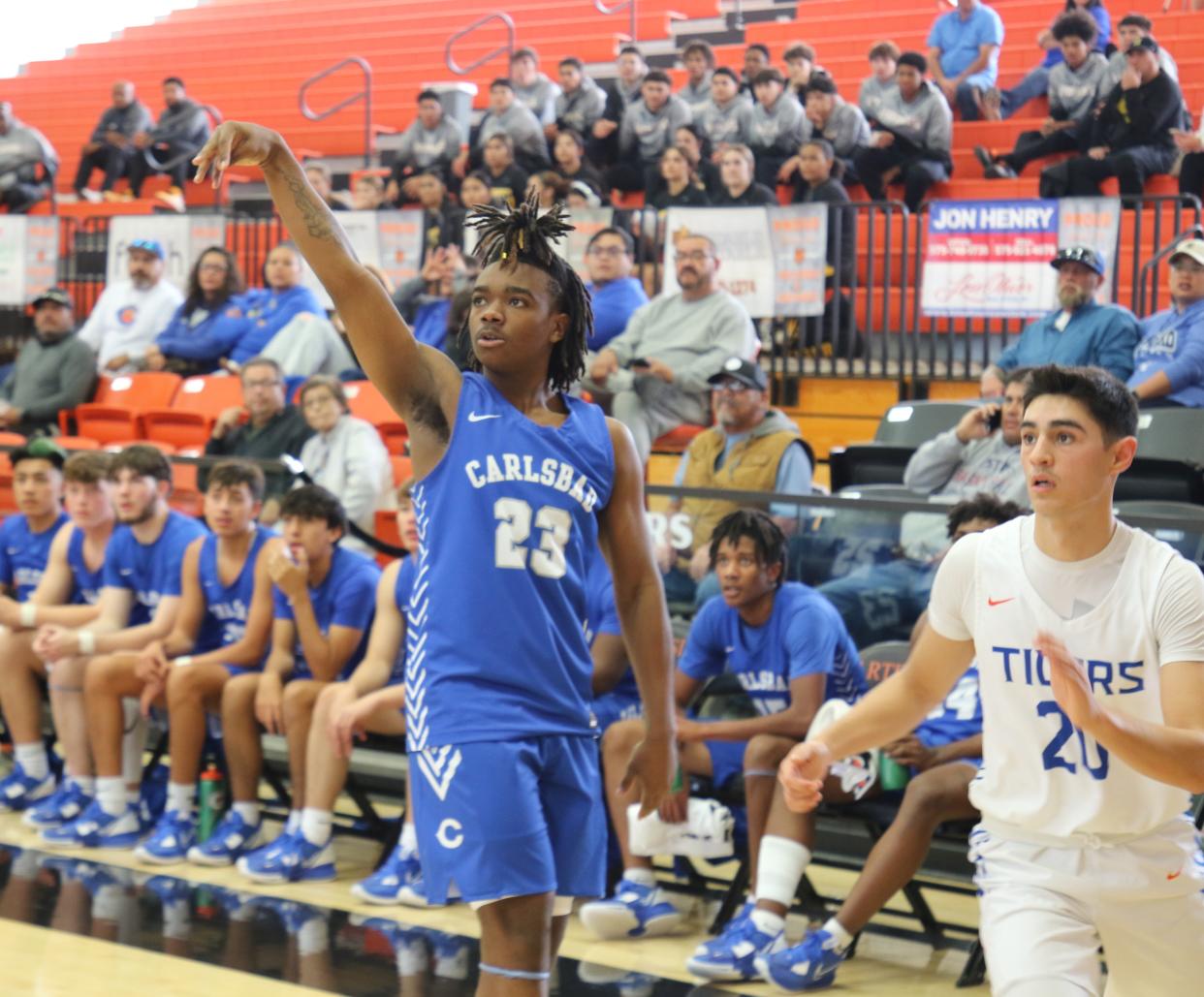 Carlsbad's RJ Amos (left) attempts a 3-point shot against Los Lunas on Dec. 1, 2022, at the City of Champions Classic in Artesia.