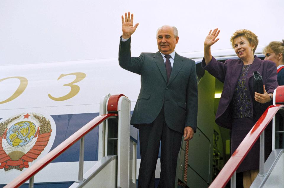 FILE - Soviet President Mikhail Gorbachev and wife Raisa wave goodbye as they board their plane bound for London on Tuesday, June. 16, 1991 in Moscow. When Mikhail Gorbachev is buried Saturday at Moscow's Novodevichy Cemetery, he will once again be next to his wife, Raisa, with whom he shared the world stage in a visibly close and loving marriage that was unprecedented for a Soviet leader. Gorbachev's very public devotion to his family broke the stuffy mold of previous Soviet leaders, just as his openness to political reform did. (AP Photo/Alexander Zemlianichenko, File)