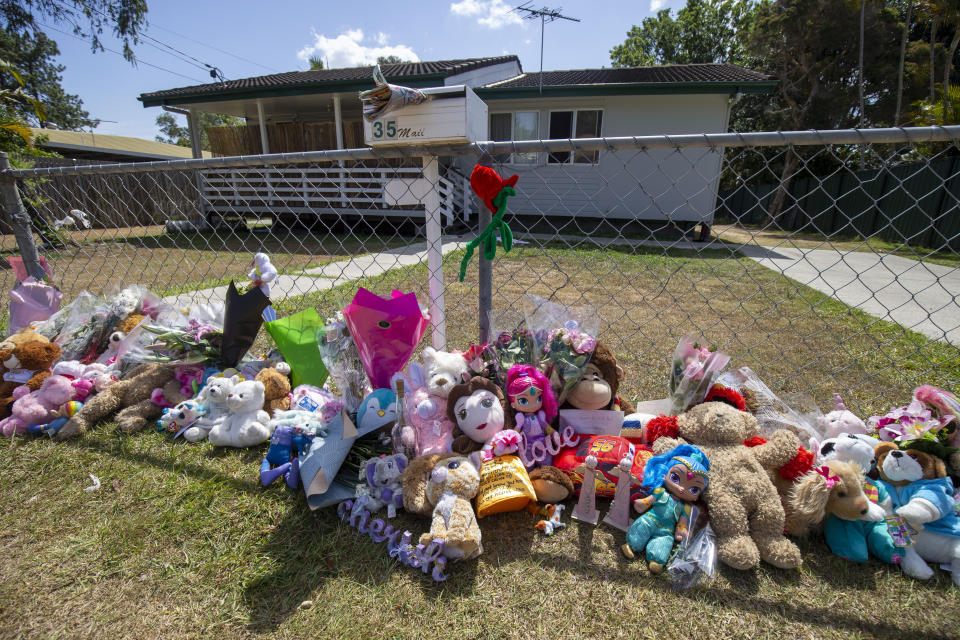 Tributes are seen at a house on Logan Reserve Road, Waterford West.