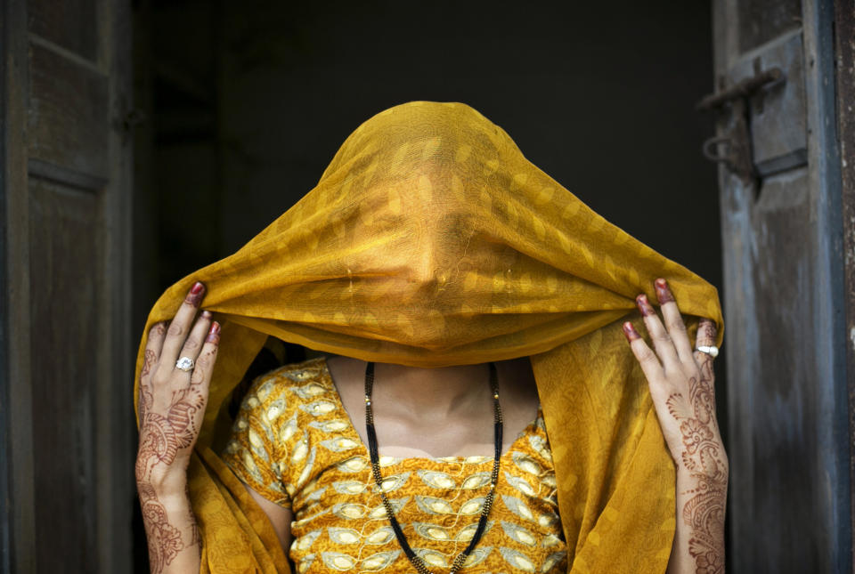 UTTAR PRADESH, INDIA - AUGUST 2: 15 year old Priyanka (name changed) poses for a photo on August 2, 2016 in Uttar Pradesh, India. She was raped by a neighbor last year when she was 14 years old. The neighbor had been harassing her for a long time and then one night he came on motorcycles with friends and threatened to kill her if she didn't get on the bike with him. He took her to a friend's house and raped her. For 10 days the police refused to register a case against him and when they did, they held her for two days in the station until she agreed to say in the statement that she went willingly with the him. Priyaka and her family say that he comes from a rich, influential family. The people in her village gossip, they say that she ran away willingly with him and that she did bad things. After the rape he continues to harass her, sending his friends to tell her that if he sees her he will kill her, that he will come and kidnap her sisters, that he will kill her father. Recently the rapist and his friends saw her father on the road and they beat up him. Two weeks ago Priyanka was wed to a 22 year old man in a marriage that her family arranged for her. They were worried about her safety and Priyanka thought that she would be safer if she was married and living in a different village. Her husband doesn't know about the rape, and the rapist has sent letters to her home threatening to tell her new family and break up the marriage. 'I feel angry. There's nothing left in me.' Priyanka says. (Photo by Getty Images)