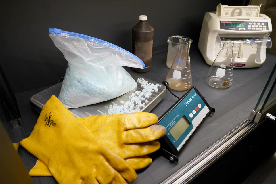 Props used on the television series "Breaking Bad", sit displayed in a case, Thursday, April 27, 2023, in Irving, Texas. A dizzying number of props, sets, and costumes from television shows beloved by generations of viewers will be sold at auction next month. The collection James Comisar has spent over 30 years amassing includes "The Tonight Show" set Johnny Carson gave him after retiring, the timeworn living room from "All in the Family," and the bar where Sam Malone served customers on Cheers. (AP Photo/Tony Gutierrez)