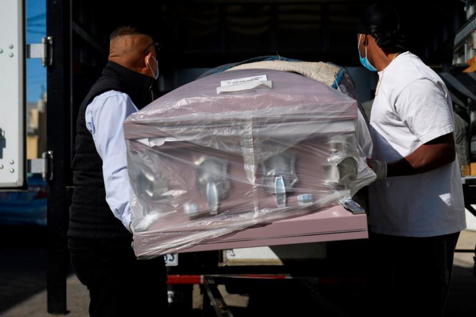 An empty casket is delivered amid a surge of Covid-19 deaths to the Continental Funeral Home.