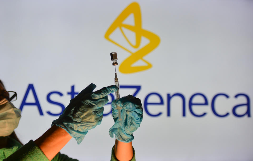 An illustrative image of a person holding a medical syringe and a vaccine vial in front of the Astra Zeneca logo displayed on a screen.
On Thursday, October 21, 2021, in Edmonton, Alberta, Canada. (Photo by Artur Widak/NurPhoto via Getty Images)