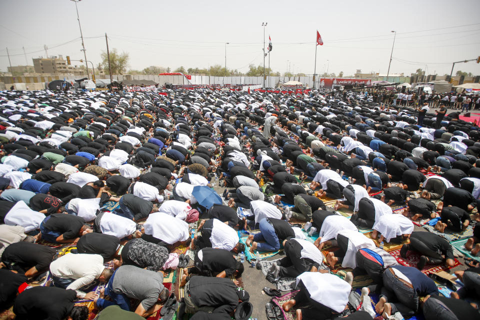 Supporters of the Shiite cleric Muqtada al-Sadr hold prayer near the parliament building in Baghdad, Iraq, Friday, Aug. 12, 2022. Al-Sadr's supporters continue their sit-in outside the parliament to demand early elections. (AP Photo/Anmar Khalil)