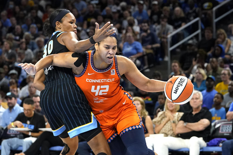 Connecticut Sun's Brionna Jones drives to the basket around Chicago Sky's Azura Stevens during the first half of Game 2 in a WNBA basketball playoffs semifinal Wednesday, Aug. 31, 2022, in Chicago. (AP Photo/Nam Y. Huh)