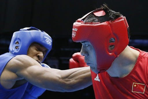 Zhilei Zhang of China (in red) defends against Anthony Joshua of Great Brintain during their Super heavyweight (+91kg) boxing quarter-finals of the 2012 London Olympic Games at the ExCel Arena, on August 6. Joshua became the fourth British boxer to reach the semi-finals and said the hunger for medals in London is driving on the home team