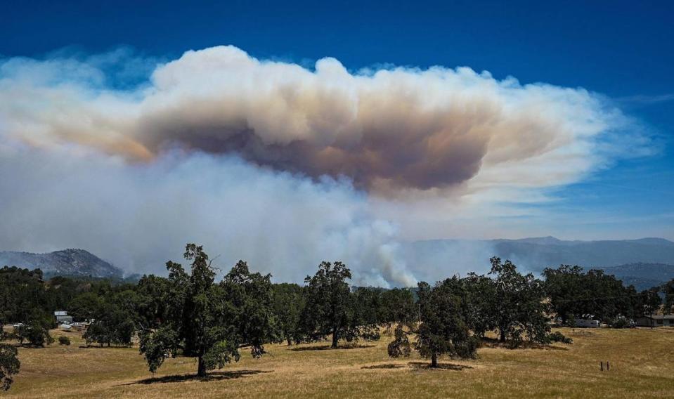 Plumes of smoke from the Oak Fire erupt from a mountainside as flames moves through the area east of Mariposa on Saturday, July 23, 2022.