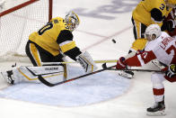 Pittsburgh Penguins goaltender Matt Murray (30) stops a shot by Detroit Red Wings' Dylan Larkin (71) during the first period of an NHL hockey game in Pittsburgh, Sunday, Feb. 16, 2020. (AP Photo/Gene J. Puskar)