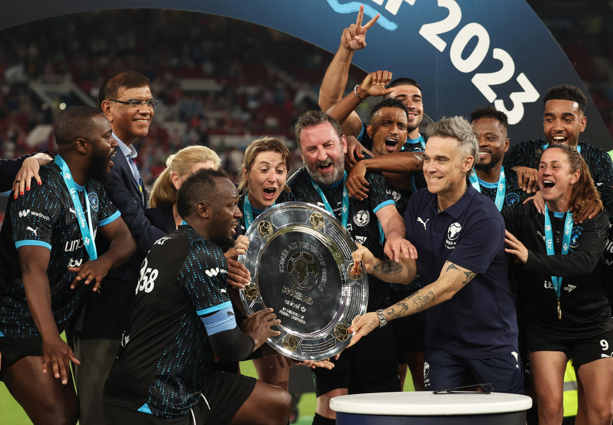 Robbie Williams, Manager of World XI awards the Soccer Aid winners shield to Players of World XI following Soccer Aid for Unicef 2023 at Old Trafford on June 11, 2023 in Manchester, England. (Photo by Matt McNulty/Getty Images)