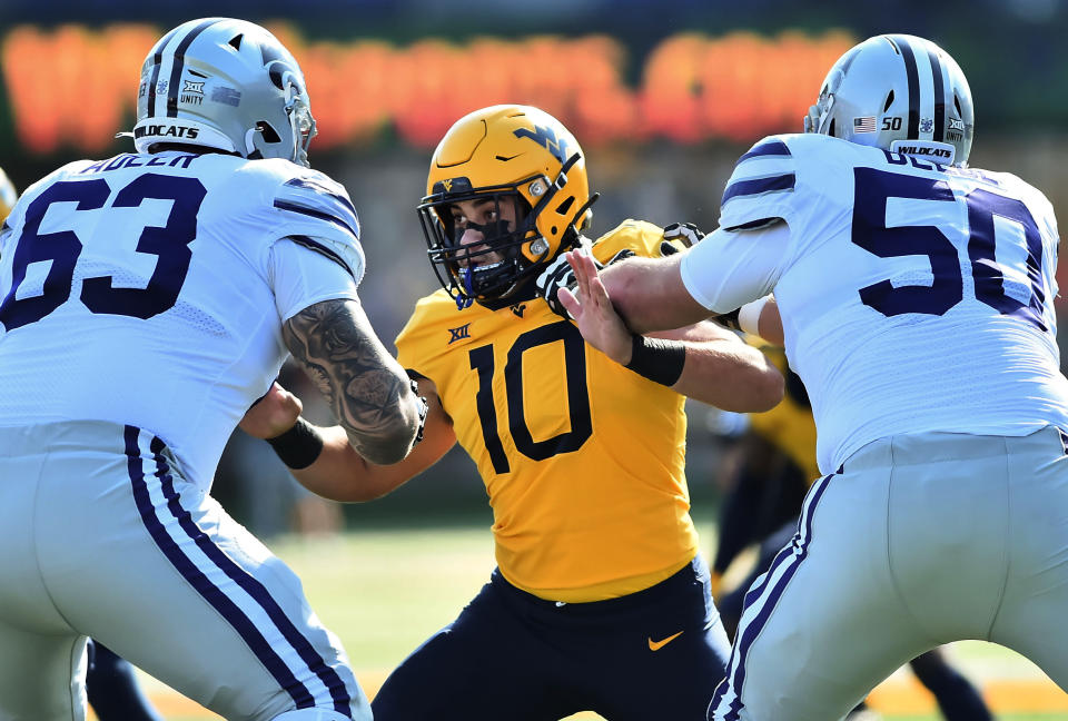 West Virginia linebacker Dylan Tonkery (10) is blocked by Kansas State defensive end Tyrone Taleni (50) during an NCAA college football game Saturday, Oct. 31, 2020, in Morgantown, W.Va. (William Wotring/The Dominion-Post via AP)