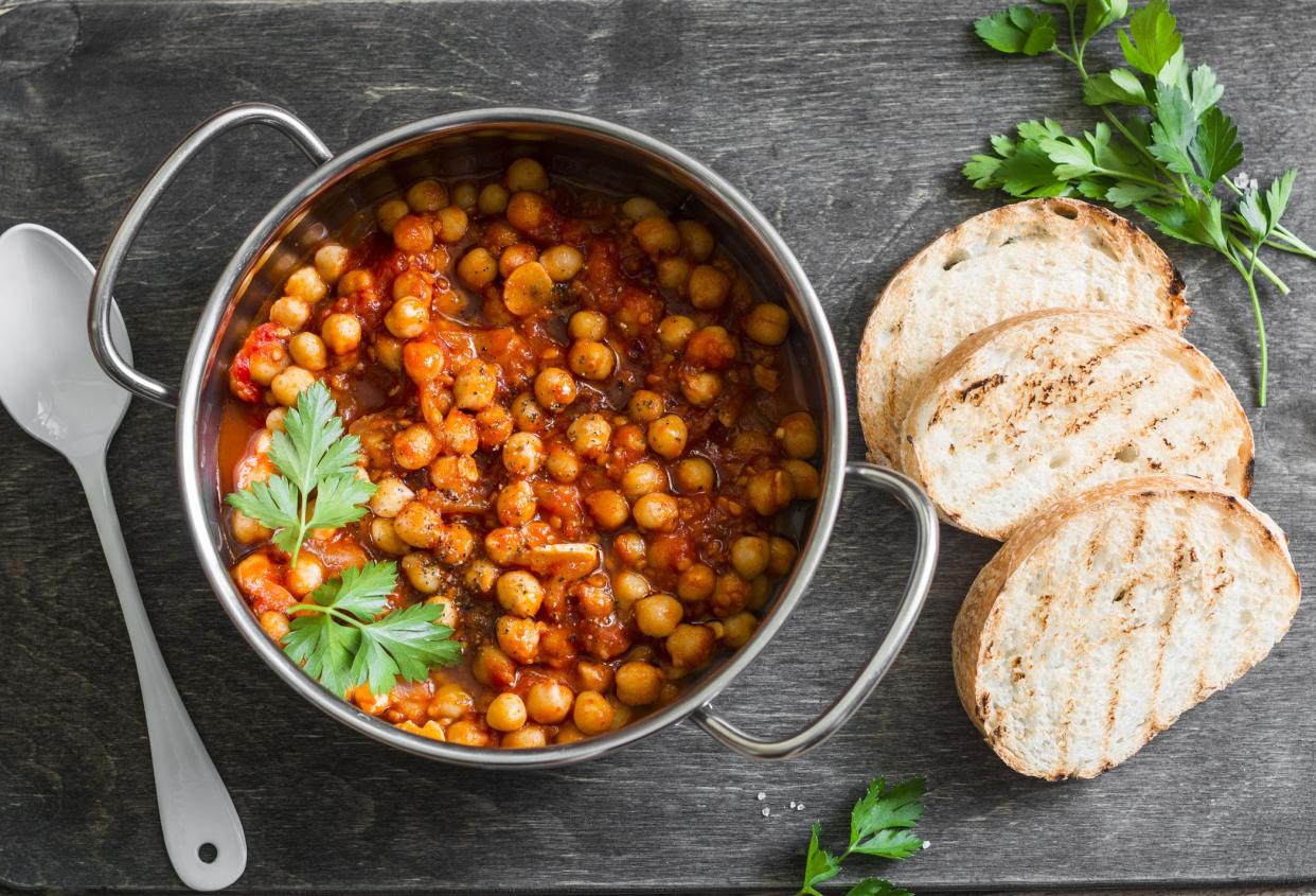 Smoked chickpeas stew. Delicious vegetarian lunch on a rustic wooden background, top view