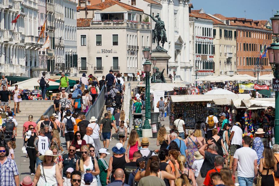 Tourists browse souvenirs stalls in Venice, Italy, on Wednesday