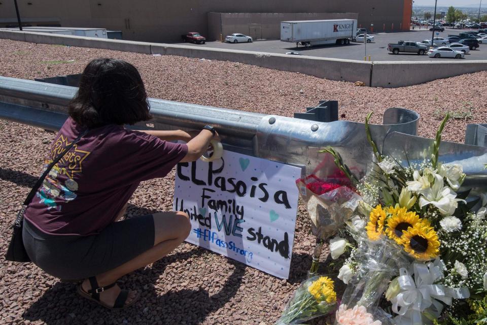 A woman places a Stay Strong sign beside a makeshift memorial outside the Cielo Vista Mall Wal-Mart (AFP/Getty Images)