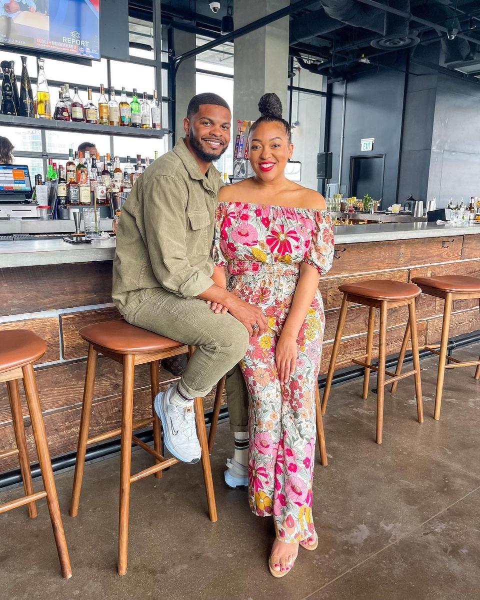 easter outfit ideas influencer jasmine katrina wearing a floral jumpsuit alongside her husband on good friday