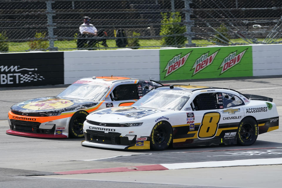 Josh Berry (8) and Noah Gragson, left, drive into turn turn two during start of the rain delayed NASCAR Xfinity Series auto race at Martinsville Speedway in Martinsville, Va., Sunday, April 11, 2021. (AP Photo/Steve Helber)