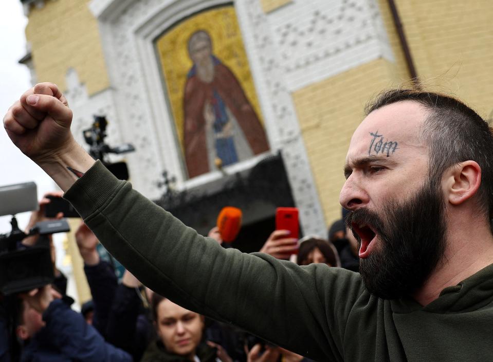 A protestor against the Ukrainian Orthodox Church accused of being linked to Moscow, shouts slogans outside a church at a compound of the Kyiv Pechersk Lavra monastery (REUTERS)